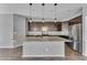 Modern kitchen with dark cabinetry, granite island, and stainless steel appliances at 19949 W Grant St, Buckeye, AZ 85326