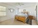 Bright bedroom with wood bed frame, nightstand, and ceiling fan at 2064 S Farnsworth Dr # 39, Mesa, AZ 85209