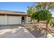 Front view of a charming single-story home with a two-car garage and a well-maintained landscape at 2064 S Farnsworth Dr # 39, Mesa, AZ 85209