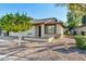 Front view of a charming single-story home with a two-car garage and a well-maintained landscape at 2064 S Farnsworth Dr # 39, Mesa, AZ 85209