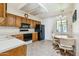 Eat-in kitchen with wood cabinets, built-in microwave, and black appliances at 2064 S Farnsworth Dr # 39, Mesa, AZ 85209