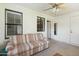 Bright sunroom features a ceiling fan and comfortable seating at 2064 S Farnsworth Dr # 39, Mesa, AZ 85209