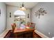 Bright dining room with wood table and arched window at 20729 N 262Nd Dr, Buckeye, AZ 85396