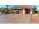 Spacious two-car garage with a decorative wood door and a large driveway at 21026 N Desert Sands Dr, Sun City West, AZ 85375