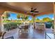 Covered patio with outdoor kitchen and seating at 21026 N Desert Sands Dr, Sun City West, AZ 85375