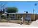 Ranch style home with a yellow exterior and a front yard at 2417 E Mobile Ln, Phoenix, AZ 85040