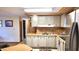 Kitchen area with light-grey cabinets and stainless steel appliances at 2464 N 56Th St, Mesa, AZ 85215