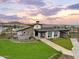 Modern clubhouse with stone exterior and landscaped lawn at 26007 N 160Th Ln, Surprise, AZ 85387