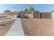 Backyard with a large grassy area, concrete pathway, and wooden fence at 2625 N 40Th Dr, Phoenix, AZ 85009