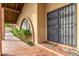 Front entry with wrought iron security door and terracotta tile flooring at 2835 N 77Th Pl, Scottsdale, AZ 85257