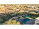 Aerial view showcasing a luxurious backyard oasis with a pool, putting green, and desert landscape at 30316 N 139Th St, Scottsdale, AZ 85262