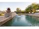 Relaxing pool with a stone waterfall feature and tranquil ambiance at 30316 N 139Th St, Scottsdale, AZ 85262