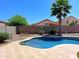 Inviting kidney shaped pool with travertine decking and landscape at 34365 N Barzona Trl, San Tan Valley, AZ 85143