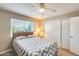 Bedroom with queen bed, nightstand, and ceiling fan at 3716 E University Dr # 2014, Mesa, AZ 85205