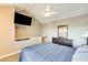 Bedroom with mounted TV and ceiling fan at 3716 E University Dr # 2014, Mesa, AZ 85205