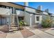 Well-maintained condo building with stairs leading to unit entrance and landscaping at 3716 E University Dr # 2014, Mesa, AZ 85205