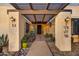 Inviting entrance with pergola and wrought iron gates at 37801 N Cave Creek Rd # 13, Cave Creek, AZ 85331