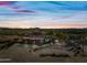 Aerial view of a single-story house with a large yard and mountain views at 5581 E Superstition Blvd, Apache Junction, AZ 85119