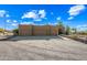 Three-car garage with gravel driveway and desert landscaping at 5581 E Superstition Blvd, Apache Junction, AZ 85119