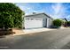 Gray exterior of manufactured home with white garage door and landscaped yard at 650 N Hawes Rd # 2840, Mesa, AZ 85207