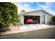 Two-car garage with golf cart and red SUV parked inside at 650 N Hawes Rd # 2840, Mesa, AZ 85207