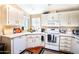 Well-equipped kitchen with white cabinets and modern appliances at 650 N Hawes Rd # 2840, Mesa, AZ 85207
