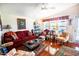 Bright living room with hardwood floors, comfy seating, and large windows at 650 N Hawes Rd # 2840, Mesa, AZ 85207
