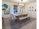 Light and airy dining room with wood table and bench seating at 7619 W Tonto Dr, Glendale, AZ 85308