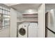 Laundry closet with washer, dryer, and shelving at 910 N Center St # 24, Mesa, AZ 85201