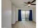 Living room with sliding door to patio and blue curtains at 910 N Center St # 24, Mesa, AZ 85201