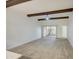 Bright living room with wood-look tile floors, exposed beams, and sliding glass doors to a patio at 910 N Center St # 24, Mesa, AZ 85201