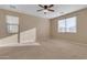 Bright and airy bedroom with two windows and ceiling fan at 1087 E Nickleback St, San Tan Valley, AZ 85143