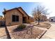 Tan house with a gravel front yard and walkway at 16501 N 68Th Dr, Peoria, AZ 85382