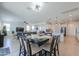 Open concept dining room with adjacent kitchen and living room at 18696 N Tanners Way, Maricopa, AZ 85138