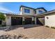 Three-car garage with dark wood doors and paver driveway at 18884 N 98Th St, Scottsdale, AZ 85255