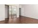 Bedroom with mirrored closet doors and wood-look floors at 21067 N Sequoia Crest N Dr, Surprise, AZ 85387