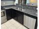 Kitchen with dark cabinets, granite counters, and stainless steel dishwasher at 2150 W Alameda Rd # 2139, Phoenix, AZ 85085