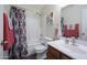 Bathroom with shower/tub combo, wood vanity, and patterned shower curtain at 23664 N Oasis Blvd, Florence, AZ 85132