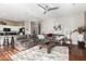 Open living room with hardwood floors and a view into the kitchen at 2733 W Glenhaven Dr, Phoenix, AZ 85045