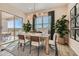 Bright dining room features a wood table, sliding glass door to backyard, and stylish decor at 3753 E Terrel St, San Tan Valley, AZ 85143