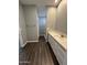 Bathroom with white vanity, quartz countertop and a walk-in shower at 4022 S 24Th Pl, Phoenix, AZ 85040