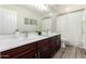 Bathroom with double sinks and dark brown vanity at 40887 W Chambers Dr, Maricopa, AZ 85138