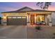 House exterior at dusk with festive lights and landscaping at 4216 E Oxford Ln, Gilbert, AZ 85295