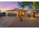 House exterior at dusk with festive lights and landscaping at 4216 E Oxford Ln, Gilbert, AZ 85295