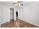 Bedroom with wood floors, ceiling fan, and spacious closet at 4360 N 186Th Ln, Goodyear, AZ 85395