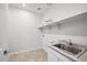 Laundry room with utility sink and shelving at 4360 N 186Th Ln, Goodyear, AZ 85395