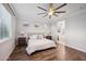 Main bedroom with king bed, en-suite bathroom access, and ceiling fan at 4360 N 186Th Ln, Goodyear, AZ 85395