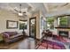 Cozy living room with fireplace, leather sofa, and hardwood floors at 4367 S Avenida De Angeles --, Gold Canyon, AZ 85118