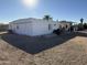 Rear view of a white mobile home with patio and desert landscaping at 451 N 68Th Ln # 168, Phoenix, AZ 85043