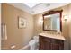 Elegant bathroom with dark wood vanity and granite countertop at 5446 W Beryl Ave, Glendale, AZ 85302